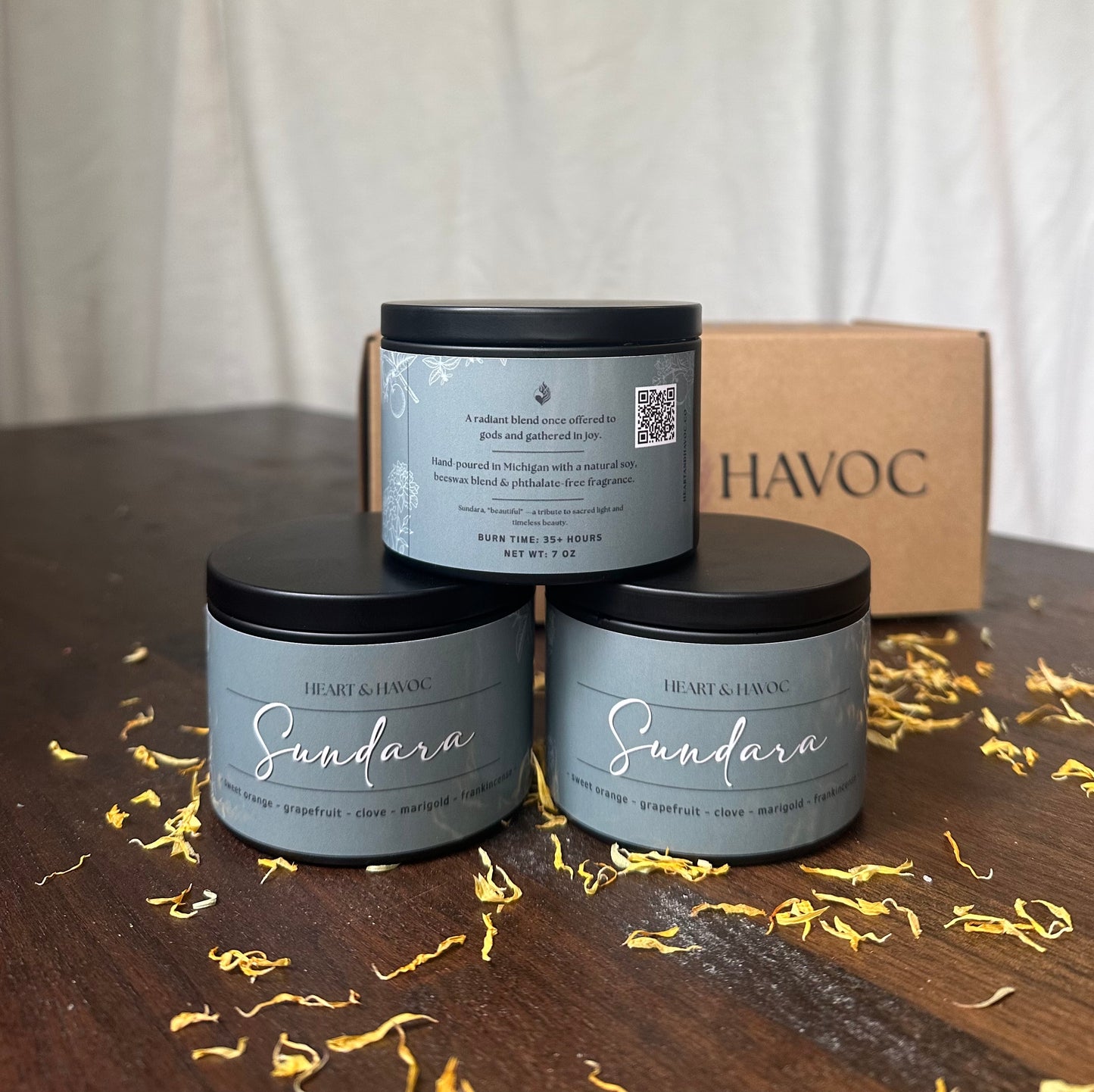Three 'Sundara' candles with a 'HAVOC' box on a wooden surface.