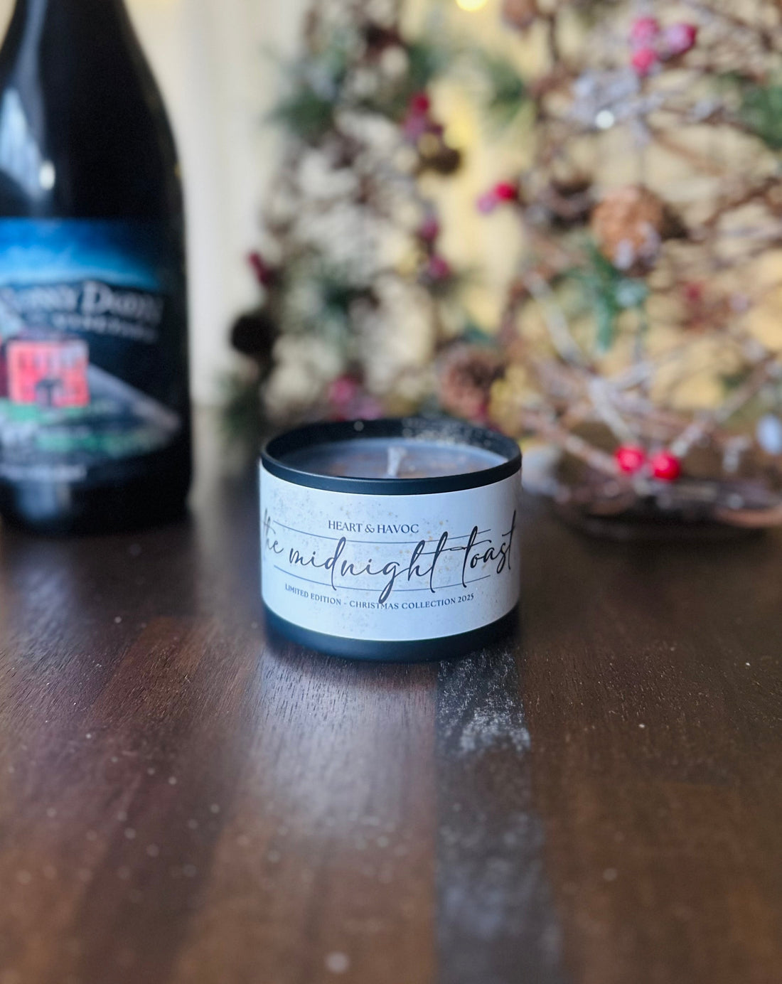 a christmas candle on a winter table with wine