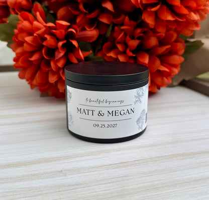 A small black jar candle with a white personalized label reading 'MATT & MEGAN' and the date '09.25.