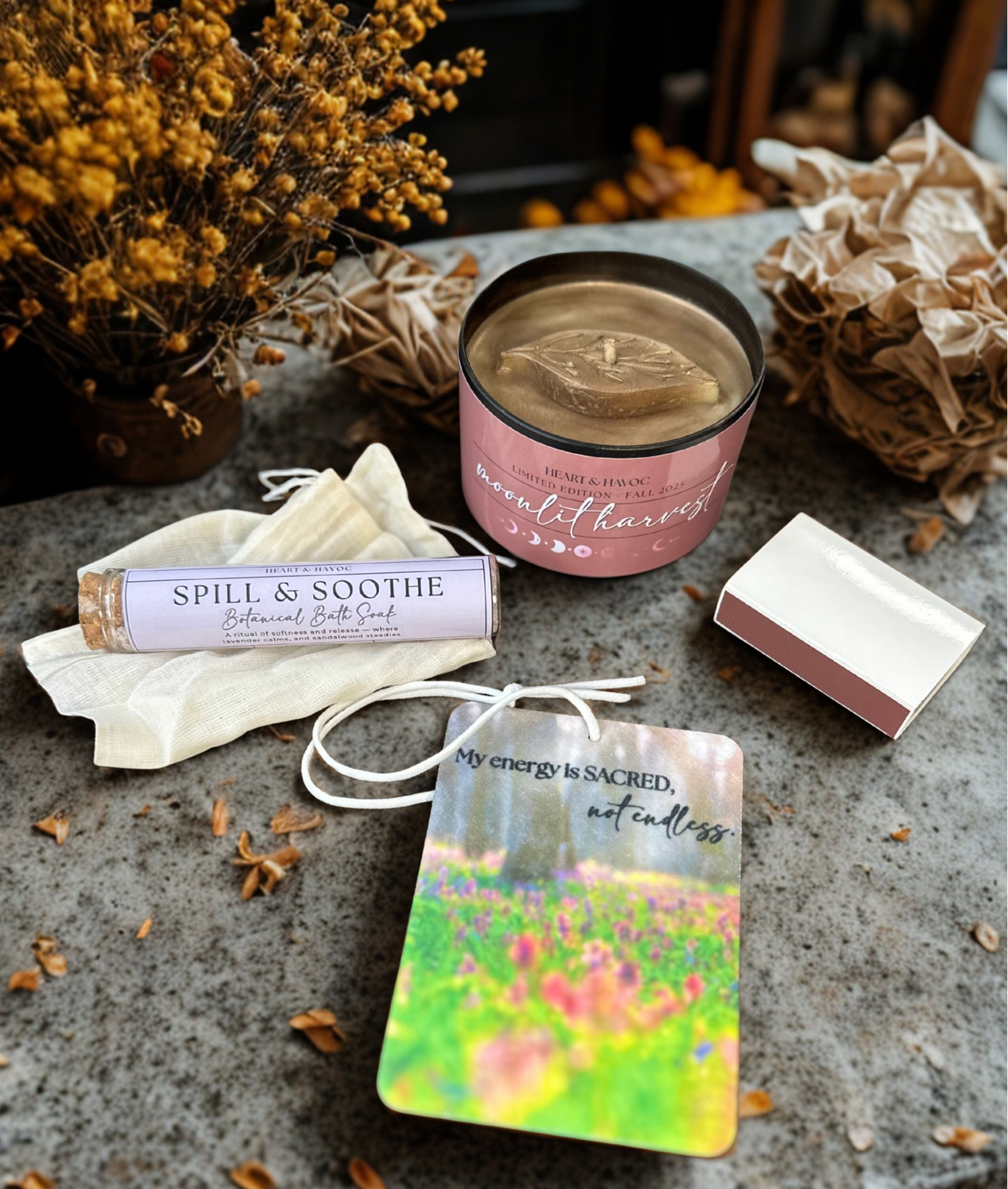 Candle, bath salt, and diffuser on a stone surface with decorative elements.