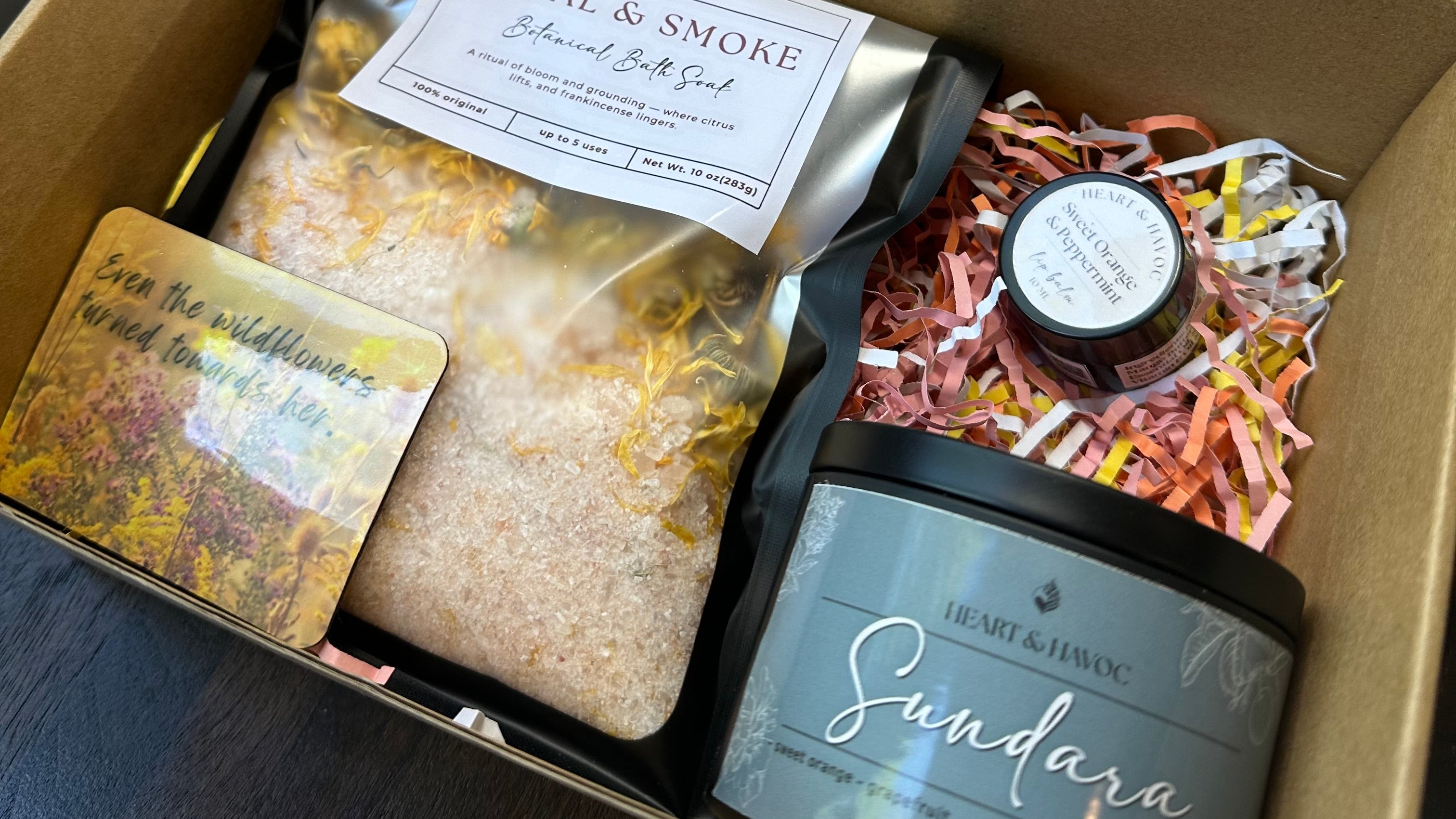 Open cardboard box containing various  self care products with visible labels.